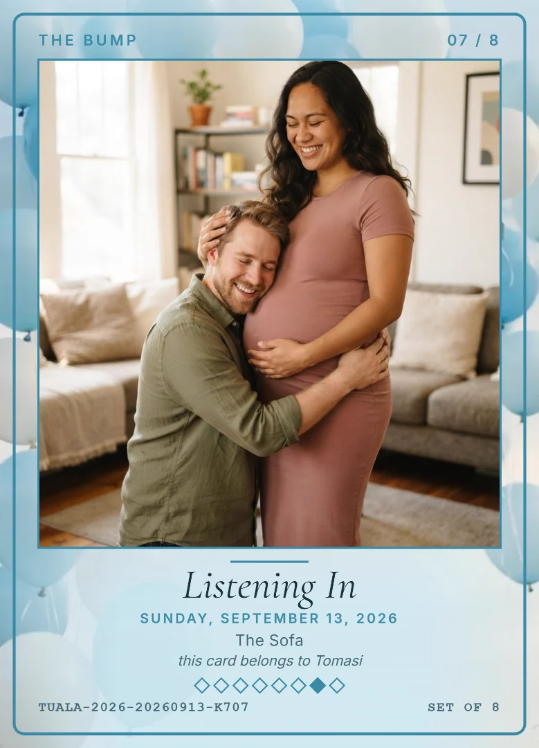 A man kneeling with his ear against his smiling wife’s bump in their living room, on a sky blue keepsake card with blue balloons and gift boxes